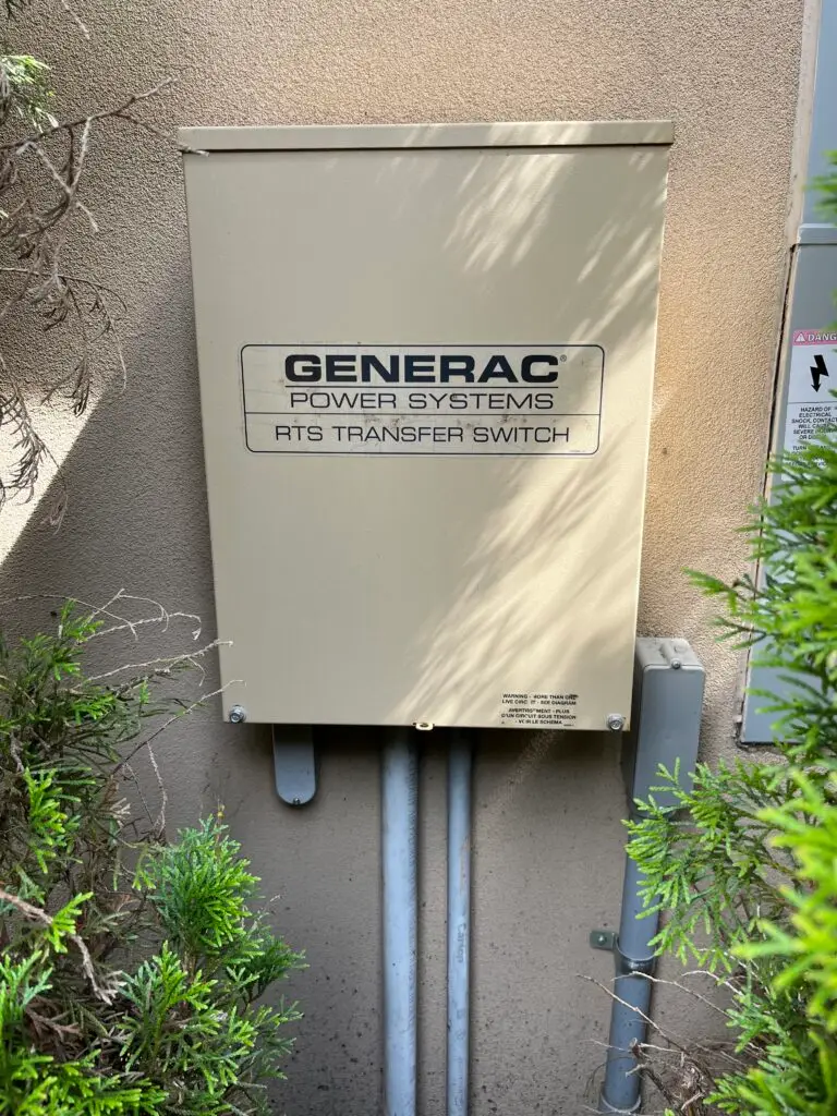 Generac RTS automatic transfer switch mounted beside a home's electrical service