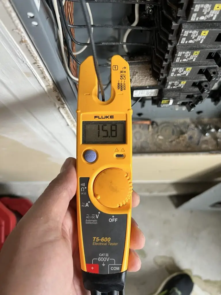 Fluke electrical tester measuring a circuit at a residential breaker panel
